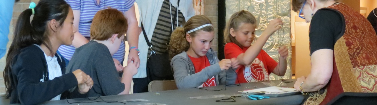 Kids make jewelry at a free family day event
