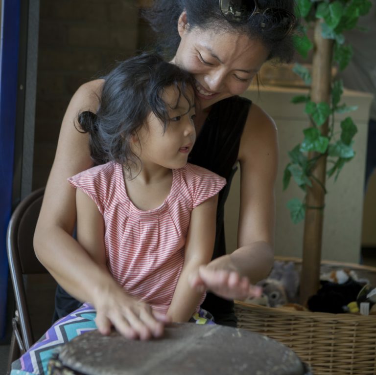 Mother and Daughter play drums at Family Fun Day