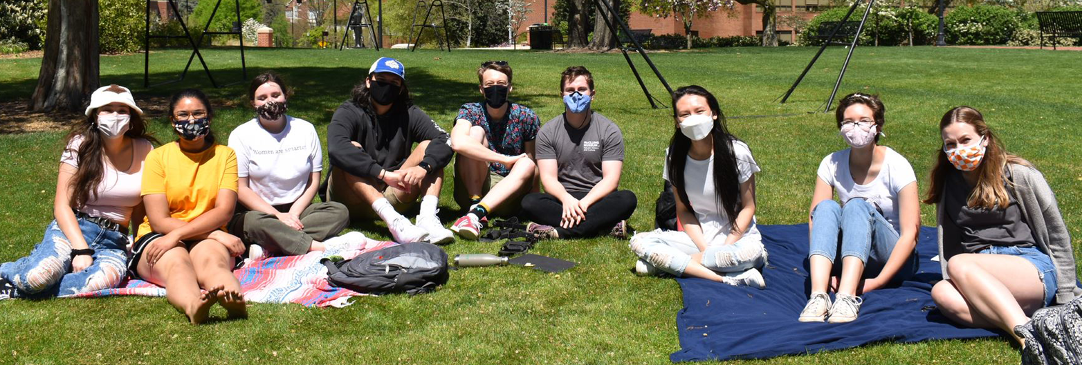 Group of students wearing masks McClung Museum students sit in the grass at Circle Park