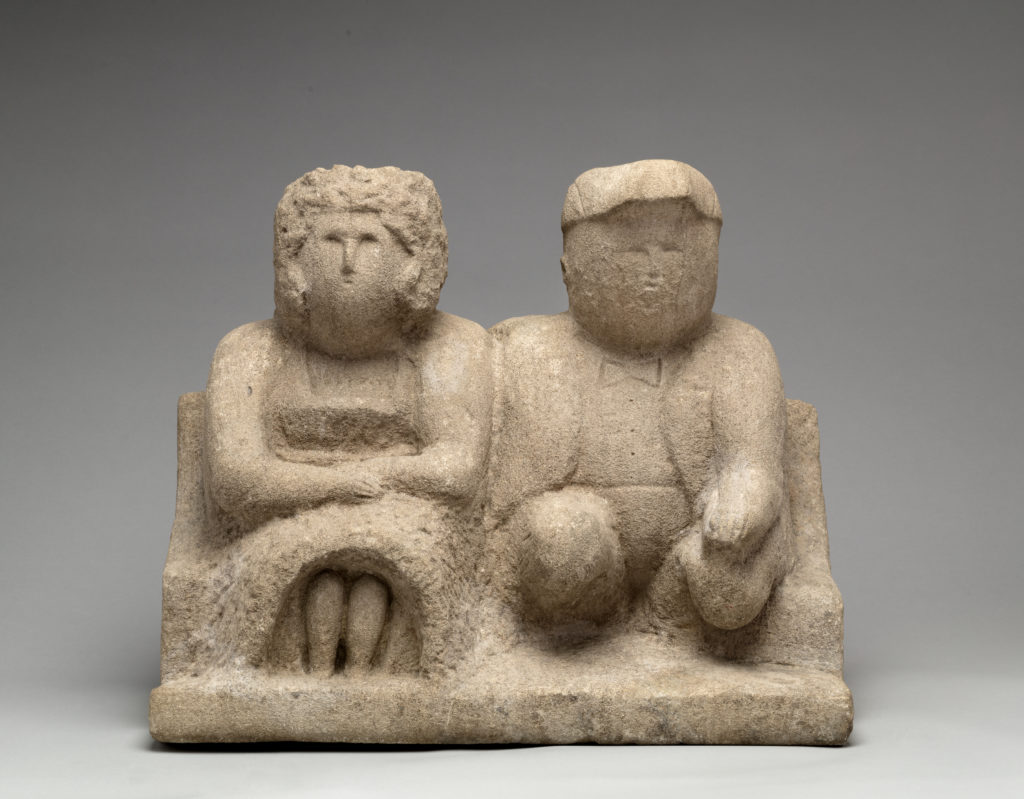 Limestone sculpture by William Edmondson of two figures sitting next to each other
