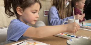 Little girl painting with water colors in the McClung Museum