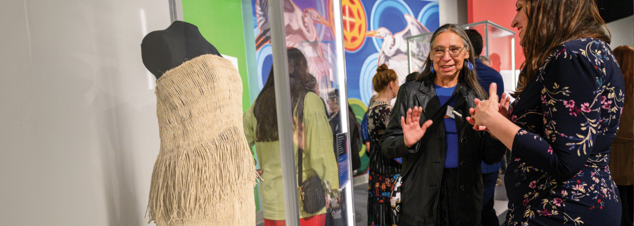 Museum member in gallery discusses piece with artist Betty Frogg